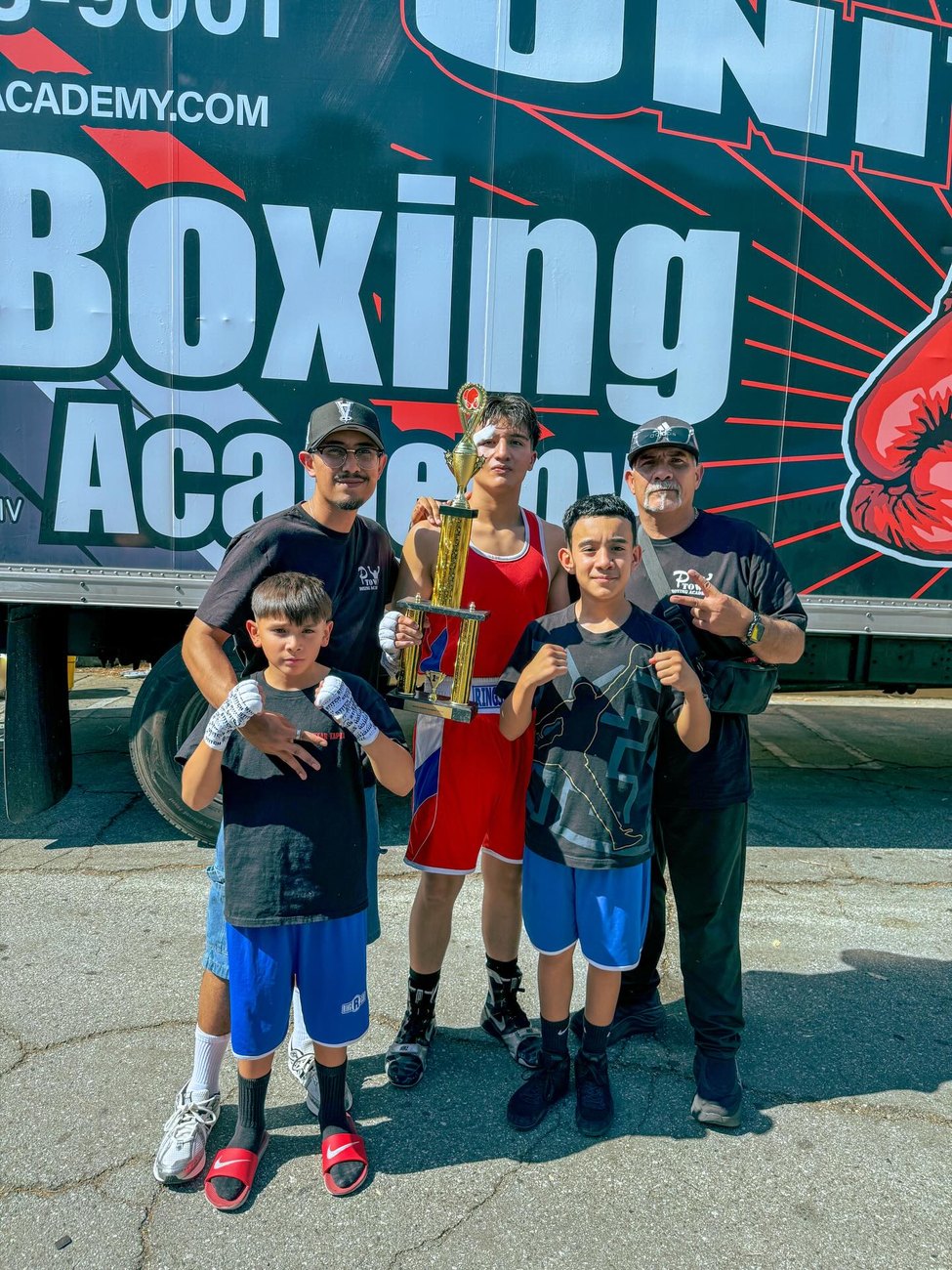 Young P-Town fighters and coaches with a trophy